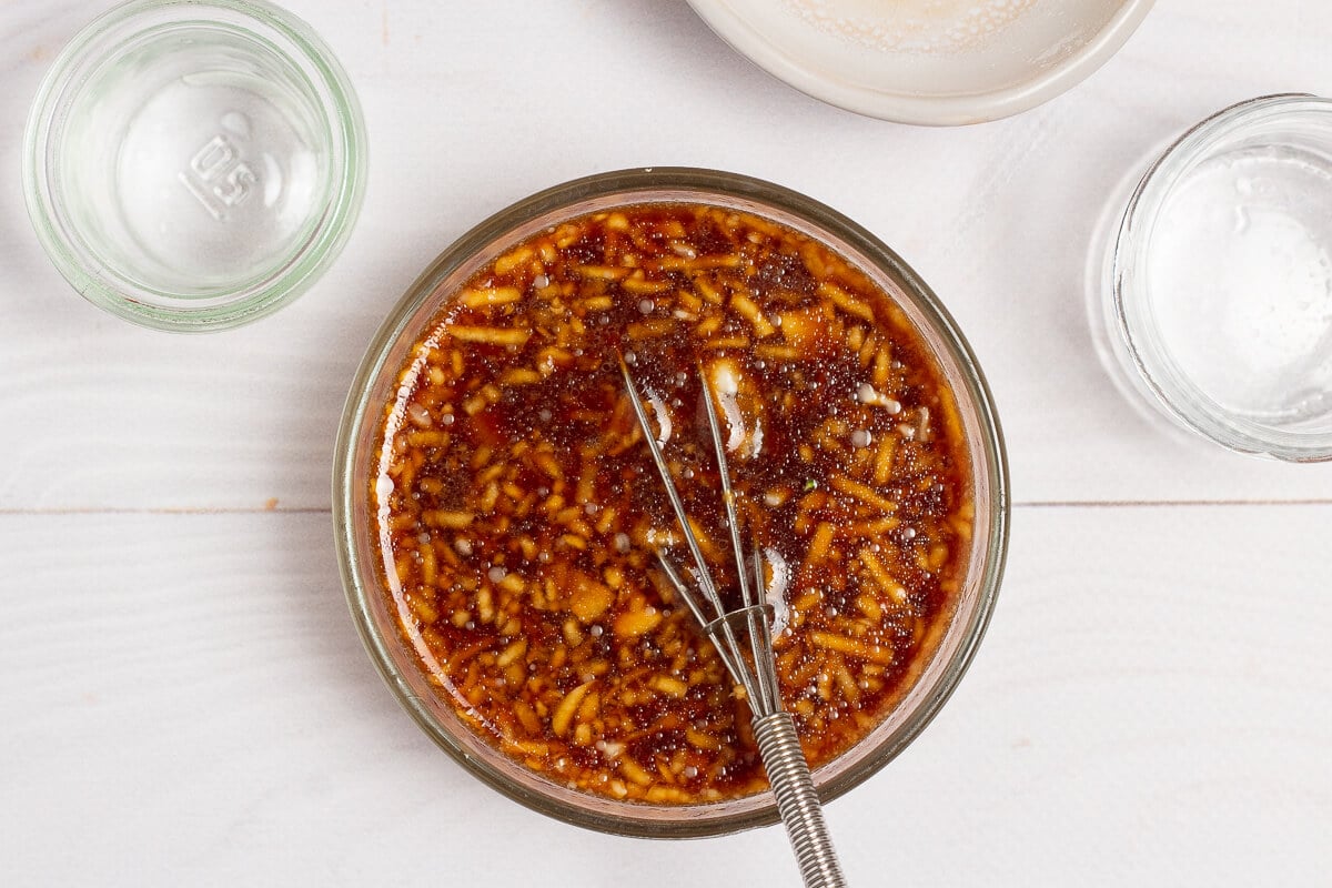 stir fry sauce and a small whisk in a bowl