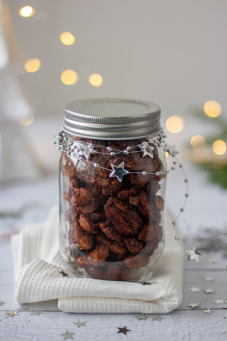Gingerbread Candied Nuts in a jar with star decoration on a table