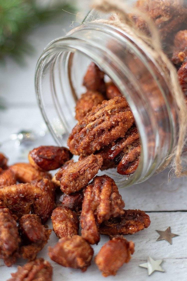 Gingerbread Candied Nuts pouring out of a jar