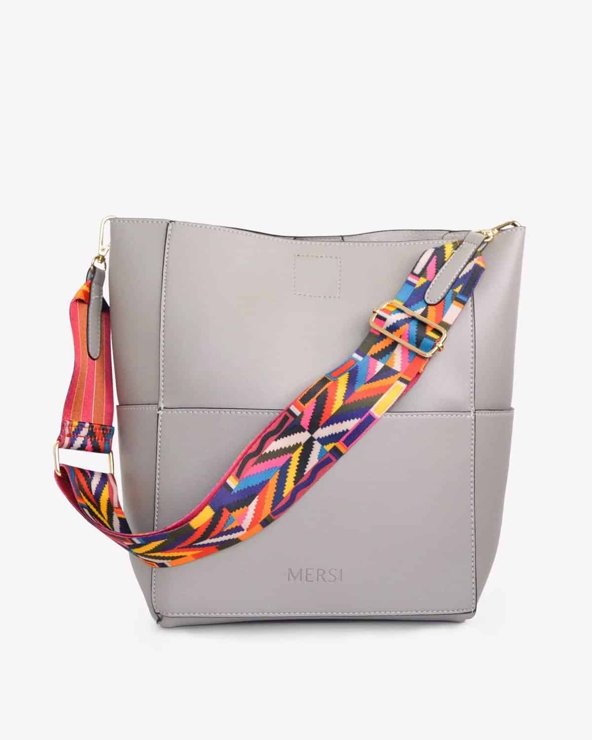 Gray Mersi bucket handbag with colorful patterned strap