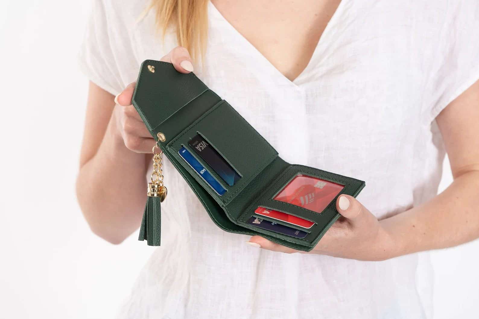Woman holding green vegan leather wallet