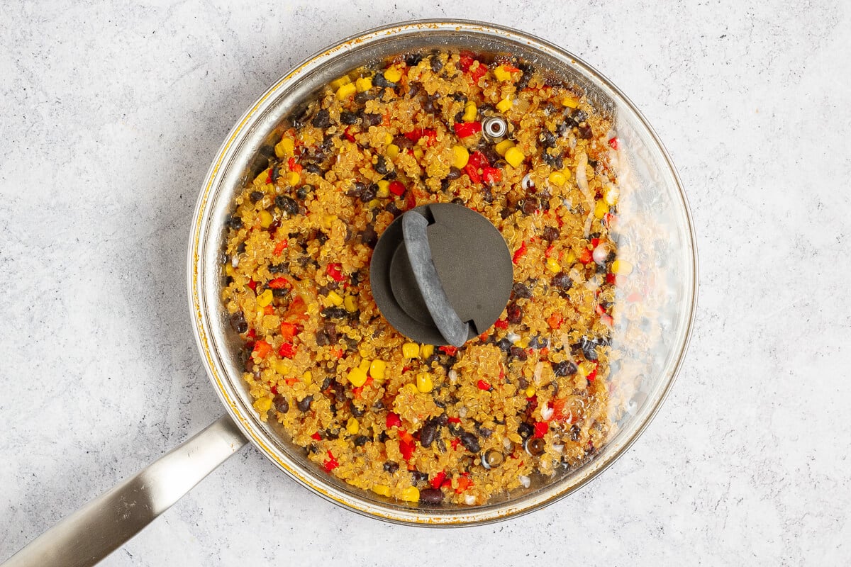 cooked mexican quinoa in a pan with a lid